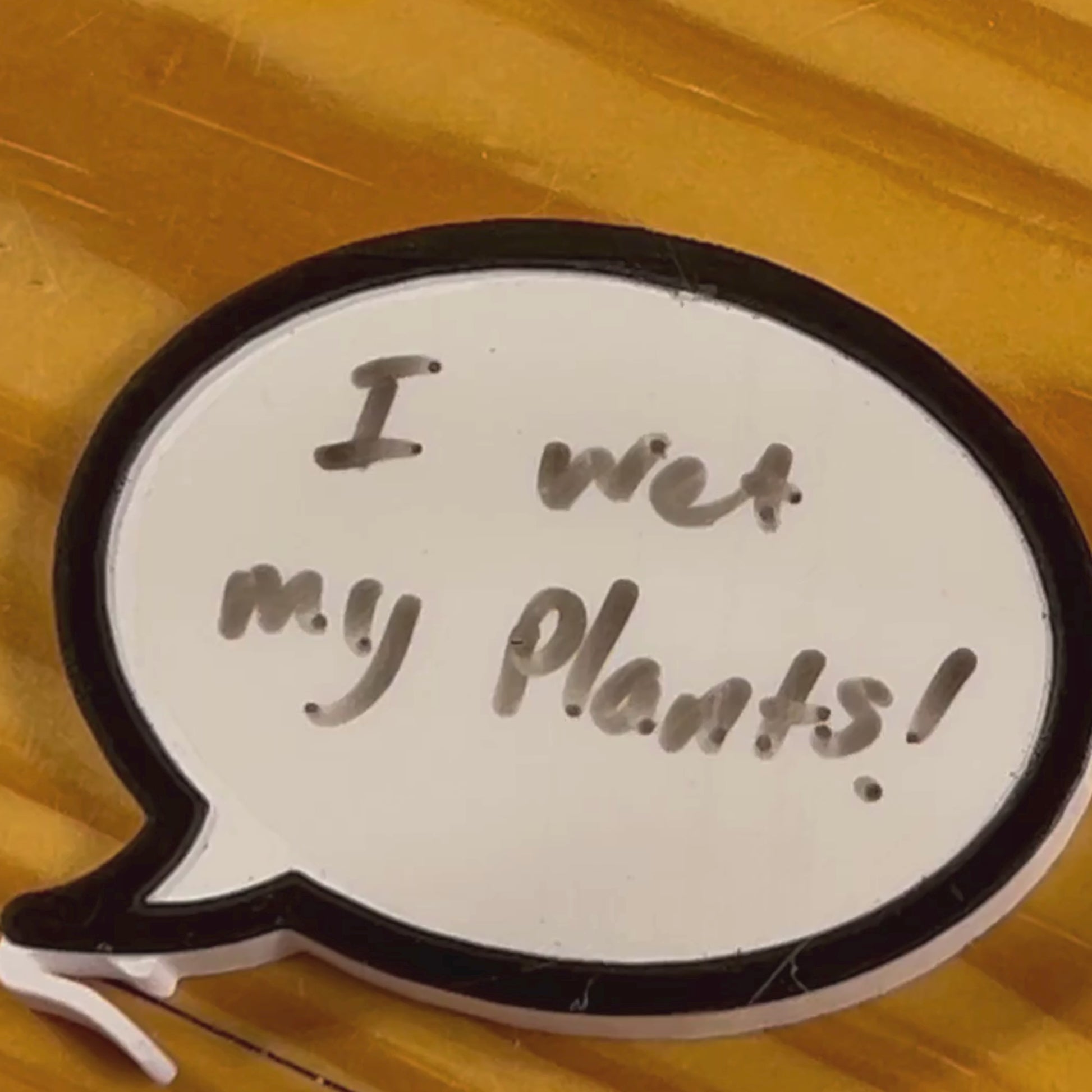 Dry erase word bubble charm in use