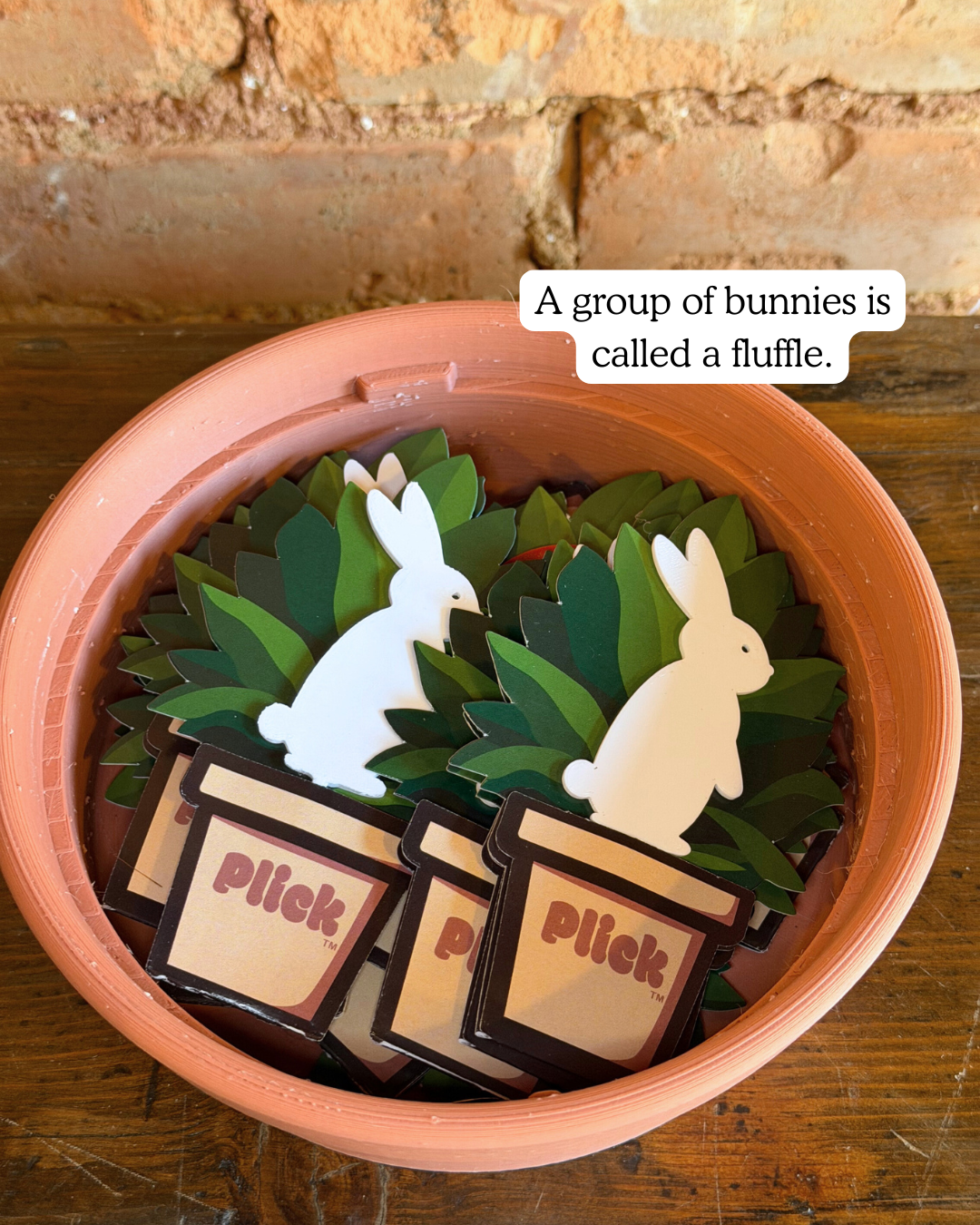 Several bunny Plicks in a container with text overlay