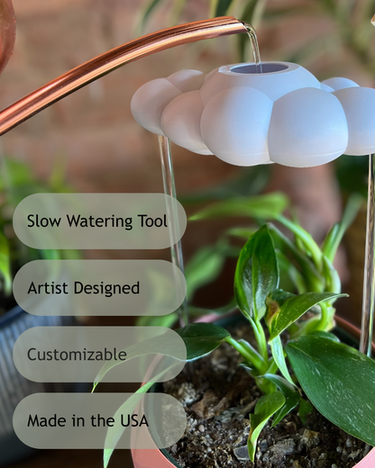 Slow watering tool for plants with text indicating features like 'Slow Watering Tool', 'Artist Designed', 'Customizable', and 'Made in the USA'.