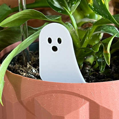 White ghost-shaped Plick in a potted plant
